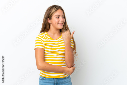Little caucasian girl isolated on white background pointing to the side to present a product