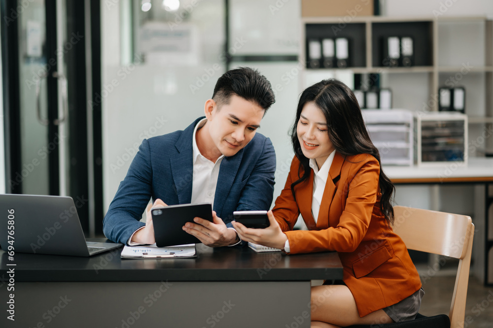 Portrait of success business people working together in modern office. Couple teamwork startup concept. Portrait of success business people working together in modern office. Couple teamwork startup concept.