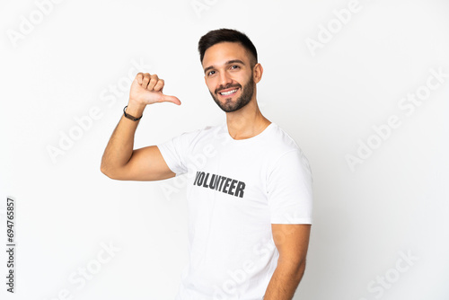 Young caucasian volunteer man isolated on white background proud and self-satisfied