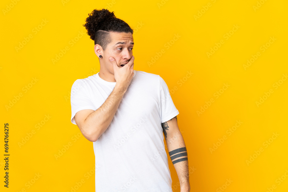 Caucasian man over isolated background doing surprise gesture while looking to the side Caucasian man over isolated background doing surprise gesture while looking to the side