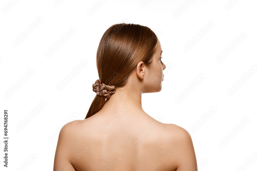 Back view portrait of brunette girl with long silky straight hair against white studio background. Skin care cosmetic treatment. Back view portrait of brunette girl with long silky straight hair against white studio background. Skin care cosmetic treatment.