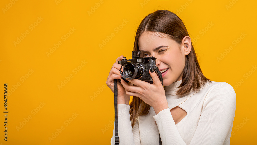 Girl with a cameras. Woman holding camera over yellow background. Girl using a camera photo. Photographing girl make photography taking concept Girl with a cameras. Woman holding camera over yellow background. Girl using a camera photo. Photographing girl make photography taking concept