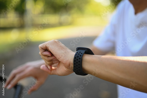 Cropped shot of sporty senior man checking his heart rate and performance on smartwatch.