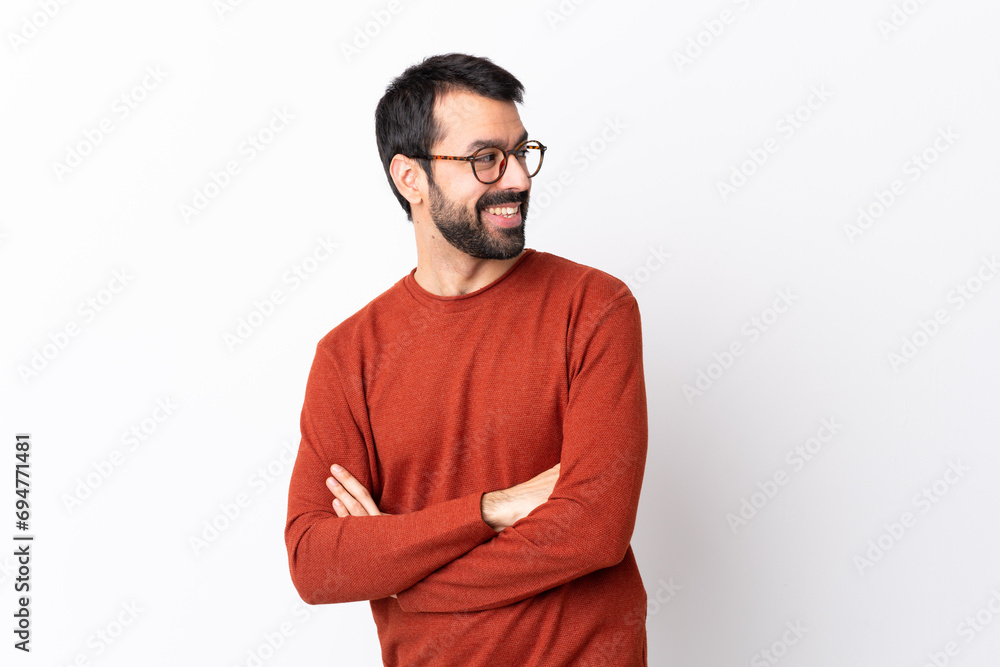Caucasian handsome man with beard over isolated white background with arms crossed and happy Caucasian handsome man with beard over isolated white background with arms crossed and happy