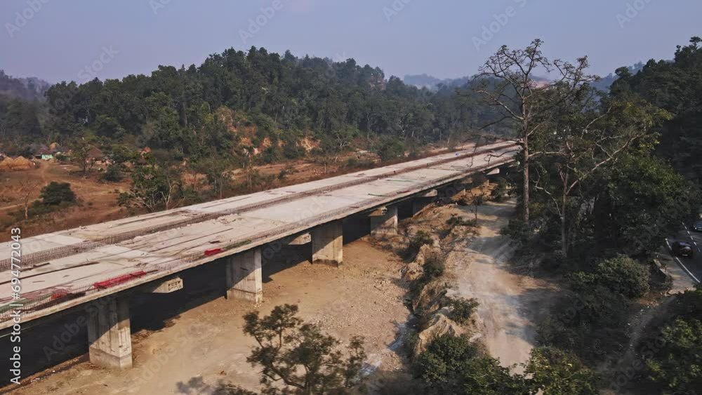Aerial drone shot of an under-construction Delhi-Dehradun Expressway, an under-construction 4-lane highway in Uttarakhand, India surrounded by mountains. Developing India Concept. Aerial drone shot of an under-construction Delhi-Dehradun Expressway, an under-construction 4-lane highway in Uttarakhand, India surrounded by mountains. Developing India Concept.