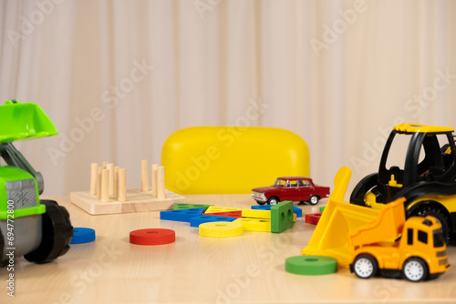 Toys of a small child - wooden blocks for the development of logic and thinking and construction machines, a place for text.