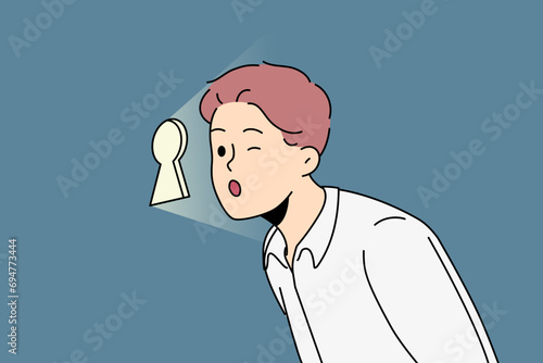 Curious business man looks through keyhole, wanting to find out corporate secrets of competitors or partners. Guy business manager spies on subordinates to avoid unwanted actions by company employees