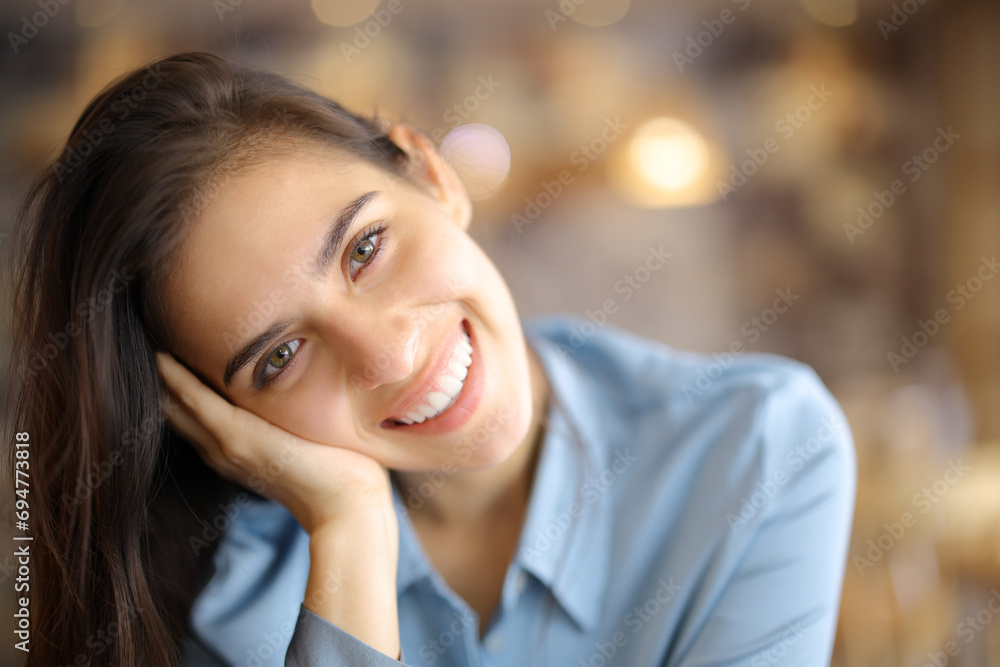 Happy woman looks at you in a bar