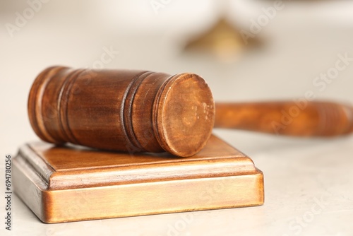 Law concept. Gavel and sound block on white table, closeup