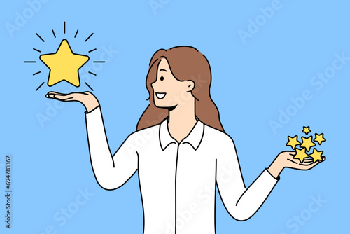 Woman holds rating stars in hands and chooses what rating to give to restaurant on website with reviews. Smiling girl in libra pose encourages you to evaluate your user experience with company