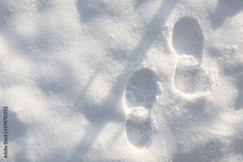 Bootprints on snow outdoors, top view. Winter season photo
