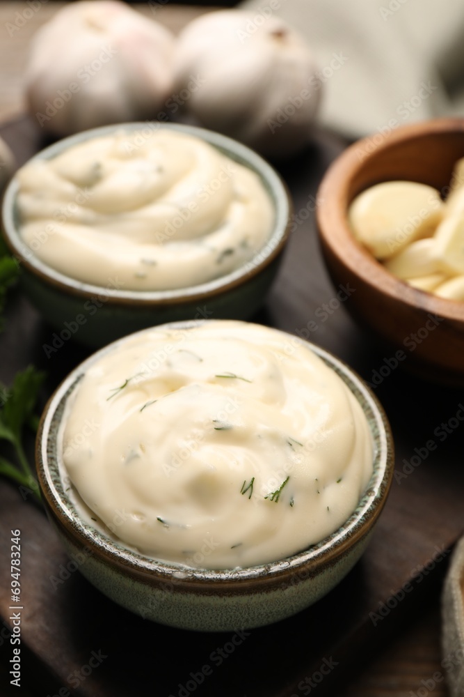 Tasty sauce with garlic on wooden table, closeup Tasty sauce with garlic on wooden table, closeup