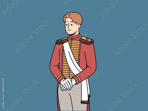 Sad aristocratic man in 18th century clothes is ready for ball or dinner party in medieval castle. Guy dressed as emperor nicholas ii to participate in aristocratic event or masquerade