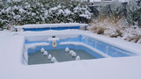 A small outdoor pool covered with snow. Pool under conservation