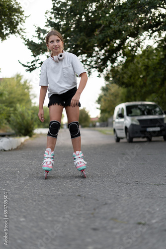 Rollerblading concept. Teen girl roller skates during inline skating outdoors. Children active lifestyle.