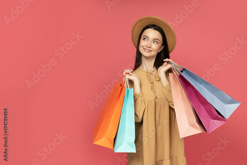 Smiling attractive young woman with shopping bags