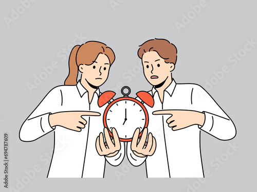 Business man and woman are holding alarm clock symbolizing deadlines that requires immediate completion. People in office clothes rant to colleagues, advising them not to violate planned deadlines