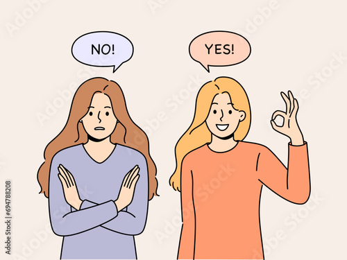 Women with opposing opinions demonstrate yes and no gestures, answering question or suggestion. Young girls with opposing views show positive and negative emotions looking at screen