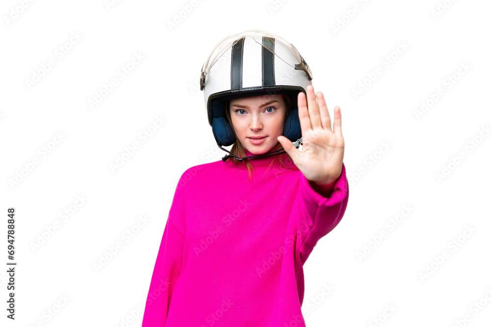 Young pretty woman with a motorcycle helmet over isolated chroma key background making stop gesture Young pretty woman with a motorcycle helmet over isolated chroma key background making stop gesture
