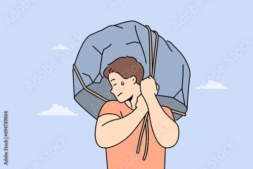 Man lifts huge stone demonstrating strength and readiness for difficult work to achieve success. Piece of rock in guy hands symbolizes difficult life circumstances that cause discomfort and suffering