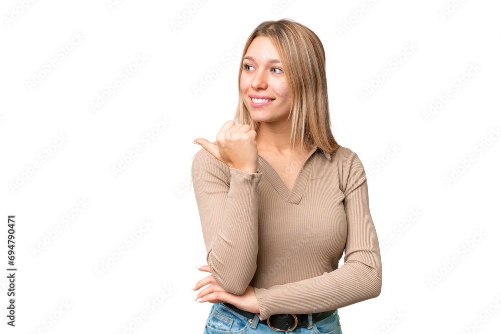 Young pretty blonde woman over isolated chroma key background pointing to the side to present a product Young pretty blonde woman over isolated chroma key background pointing to the side to present a product
