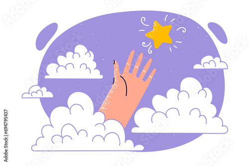 Hand is trying to reach star located in sky among clouds, for concept of striving for success