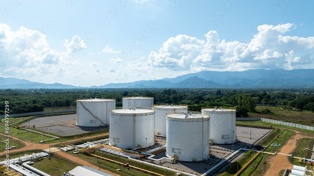 Fototapeta premium Aerial view fuel storage tank oil, Large white industrial for tank oil., Crude oil export factory industry storage tank industrial pipes, Business petrochemical industrial.