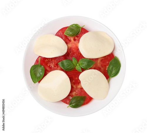 Plate of delicious Caprese salad with tomatoes, mozzarella and basil isolated on white, top view