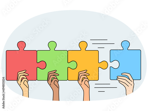 People connect jigsaw puzzle pieces