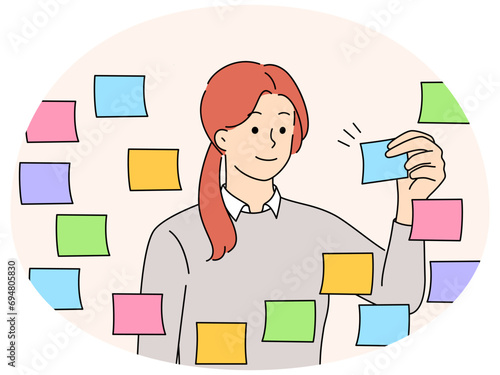 Businesswoman work with sticky notes on board