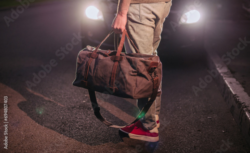 Man hold brown shoulder canvas bag in hand photo