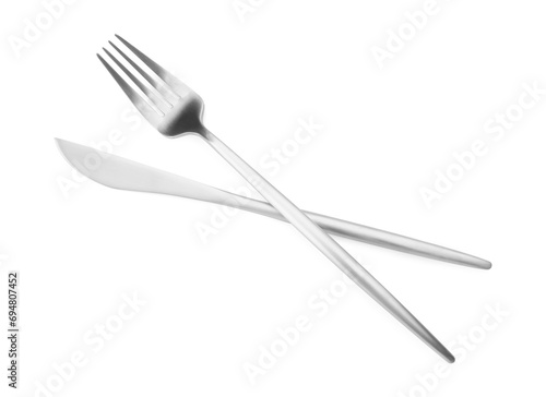 Shiny silver fork and knife isolated on white, top view. Luxury cutlery