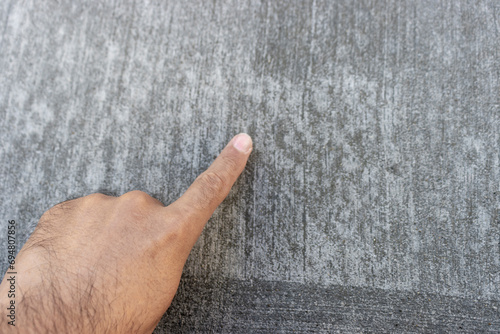 養生中のコンクリートを触る男の手 photo