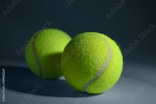 Two tennis balls on dusty light blue background, closeup © New Africa