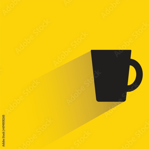water glass with shadow on yellow background