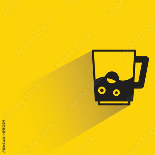 water glass with shadow on yellow background