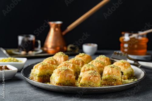 Delicious fresh baklava with chopped nuts on grey table. Eastern sweets