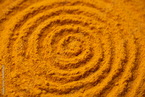 Heap of turmeric powder. Condiment or dietary supplement.