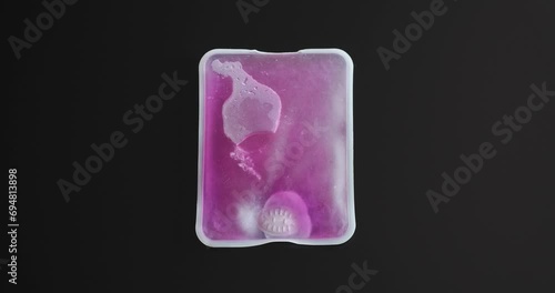 Reusable hand warmer exothermic reaction shows crystals spread with heat release.  Winter accessory for cold hands, extremities.