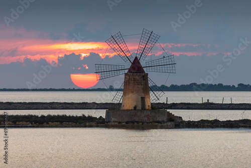 Italy, Sicily, Trapani, Marsala, a windmill on the salt pans photo