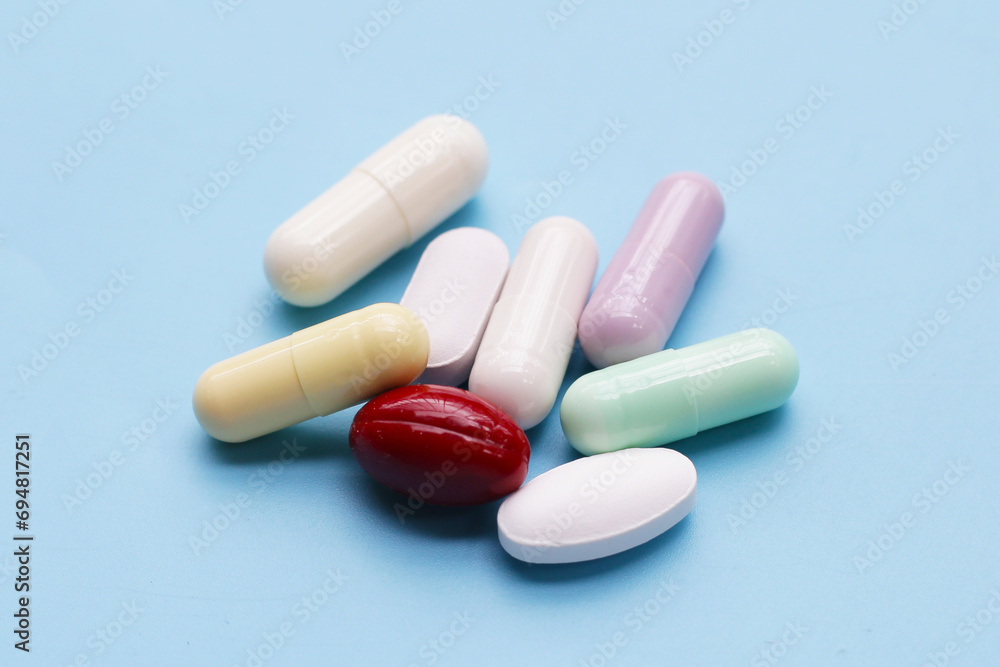 Colorful capsules and pills on blue background. Colorful capsules and pills on blue background.