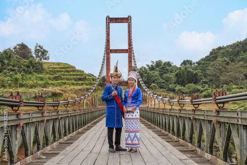 young couple of Rawang people in traditional Rawang dress at Kaungmulone Bridge across Mali Kha River in Putao, Kachin state. Myanmar photo