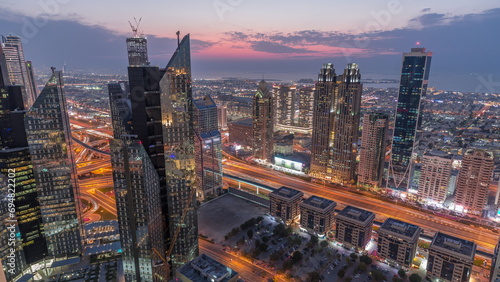 High-rise buildings on Sheikh Zayed Road in Dubai aerial day to night timelapse, UAE.