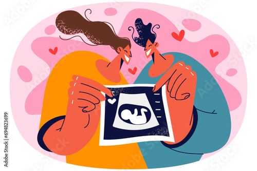 Happy couple show ultrasound scan