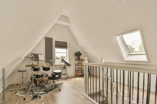 Drum set and staircase in spacious loft photo
