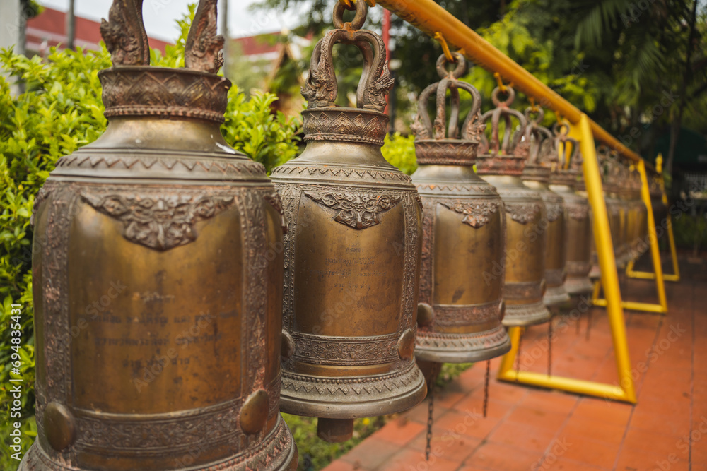 Row of bells hanging in ancient Buddhist temple in Thailand Row of bells hanging in ancient Buddhist temple in Thailand