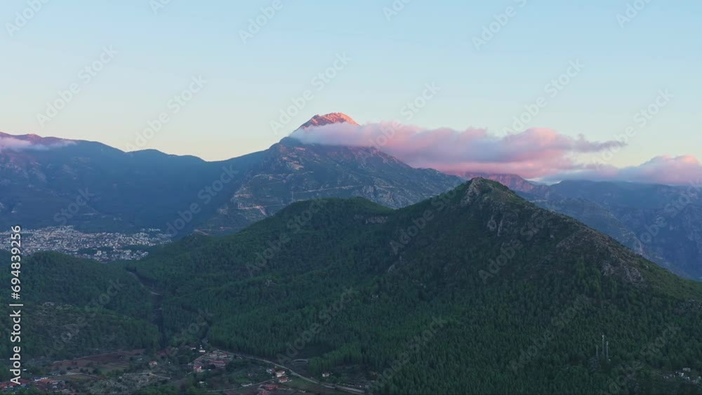Aerial view of mountain peak lighten by sunset light. Famous Babadag mountain in Oludeniz, Fethiye, Turkiye Aerial view of mountain peak lighten by sunset light. Famous Babadag mountain in Oludeniz, Fethiye, Turkiye