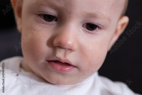 Photos Face of a smiling baby boy with snot from his nose