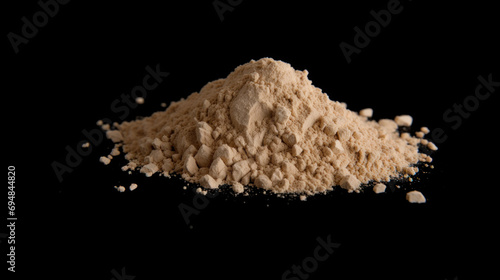 Heap of brown powder depicting heroin isolated on black background photo