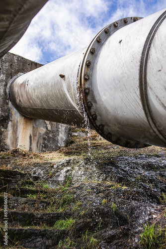 Water leaking from huge old pipeline photo